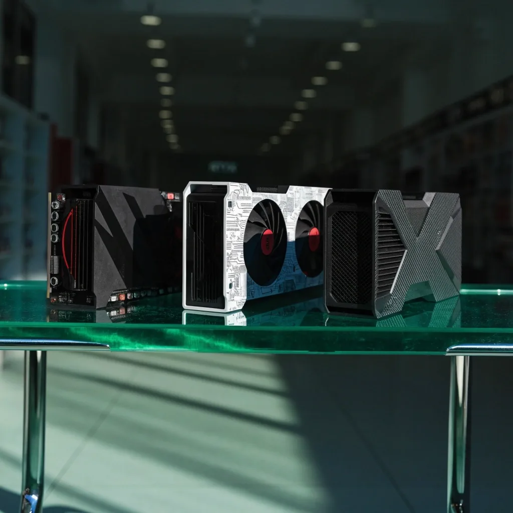 Three RTX 50-series cards on chrome stands on a lit emerald acrylic shelf under crisp daylight